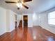 Living room with hardwood floors, a ceiling fan, and stairs at 7800 Highbanks Ct, Charlotte, NC 28212