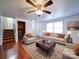 Living room with hardwood floors, ceiling fan, and staged furniture at 7800 Highbanks Ct, Charlotte, NC 28212