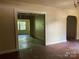 Open living area with hardwood floors and exposed support beams at 1035 Gibson St, Albemarle, NC 28001