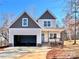 Two-story house with gray and beige siding, a two-car garage, and a light blue front door at 122 Arrowood Ln, Harmony, NC 28634