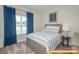 Cozy bedroom with a striped bedspread and blue curtains at 6316 Honor Ave, Midland, NC 28107