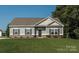 Newly constructed ranch home with gray siding, brick accents, and a well-manicured lawn at 6318 Honor Ave, Midland, NC 28107