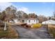 White ranch home with a long driveway and American flag at 1540 E Ridge Rd, Salisbury, NC 28144