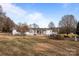 Ranch home with a long driveway and a statue at 1540 E Ridge Rd, Salisbury, NC 28144