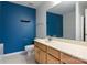 Bathroom with a tub, vanity, and blue accent wall at 2856 Summergrove Ct, Matthews, NC 28105