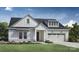 Charming farmhouse style home with white siding, landscaping, and two-car garage at 4107 Eastover Glen Rd # 0350, Charlotte, NC 28269