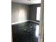 Simple bedroom with dark hardwood floors and gray walls at 415 Lakewood Ave, Charlotte, NC 28208