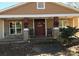 Inviting front porch with stone details and a charming red door at 415 Lakewood Ave, Charlotte, NC 28208