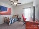 Cozy bedroom with a twin bed, desk, and American flag at 442 Hunton Forest Nw Dr, Concord, NC 28027