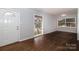 Hardwood floor living room with white door and windows at 4658 Murrayhill Rd, Charlotte, NC 28209