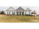 Charming two-story house with gray siding, stone accents, and a well-manicured lawn at 6319 Honor Ave, Midland, NC 28107