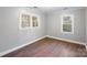 Spacious bedroom with hardwood floors and two windows at 634 Colston St, Albemarle, NC 28001