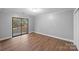 Bedroom with sliding glass door to deck and hardwood floors at 634 Colston St, Albemarle, NC 28001