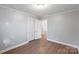 Bedroom with hardwood floors, closet, and access to another room at 634 Colston St, Albemarle, NC 28001