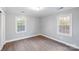 Simple bedroom with hardwood floors and two windows at 634 Colston St, Albemarle, NC 28001