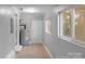 Bright laundry room with tile flooring, water heater, and exterior access at 634 Colston St, Albemarle, NC 28001