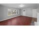 Living room with hardwood floors and large windows at 634 Colston St, Albemarle, NC 28001