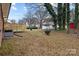 Large backyard with shed and mature trees, showing the back of the house and deck at 840 Belmorrow Dr, Charlotte, NC 28214