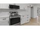 Stainless steel appliances and white shaker cabinets in this updated kitchen at 840 Belmorrow Dr, Charlotte, NC 28214