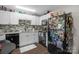 Modern kitchen features white cabinets, granite countertops, and black appliances at 1576 Hunt Club Ct, Rock Hill, SC 29732