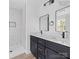 Modern bathroom with double vanity, marble shower, and matte black fixtures at 211 Chestnut St, Shelby, NC 28150