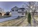 Two-story white house with black windows, a driveway, and landscaping at 2118 Brantley Rd, Kannapolis, NC 28083