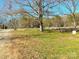Front yard with large tree and gravel driveway at 3100 Nc Hwy 18 Hwy, Vale, NC 28168