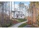 A charming two-story white house with a long driveway surrounded by trees at 4171 Island Fox Ln, Denver, NC 28037