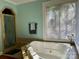 Relaxing bathroom with a large bathtub, window, and neutral colors at 511 W Stevens Dr, Kershaw, SC 29067