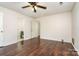 Spacious bedroom with wood-look floors and access to bathroom at 616 Cricketwood Ln, Charlotte, NC 28215