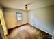 Small bedroom with worn carpet and a window at 8717 Windsong Dr, Charlotte, NC 28273