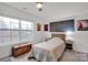 Bright bedroom with a double bed, window, and wood-toned dresser at 132 N Shayna Rd, Troutman, NC 28166