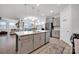 Modern kitchen with island, stainless steel appliances, and light gray cabinets at 132 N Shayna Rd, Troutman, NC 28166