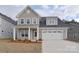 Two-story house with gray siding, white trim, and a two-car garage at 1374 Cedardale Ln # 33, Denver, NC 28037