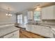 Kitchen with white cabinets, granite countertops, and access to backyard at 306 Tinderbox Ln, Fort Mill, SC 29708