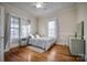 Cozy bedroom with hardwood floors and a light green dresser at 400 N Ashe Ave, Newton, NC 28658