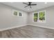 Bright bedroom with wood-look floors and multiple windows at 4448 Triumph Sw Dr, Concord, NC 28027