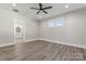 Spacious bedroom with wood-look flooring and an ensuite bathroom at 4448 Triumph Sw Dr, Concord, NC 28027