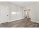 Hardwood floor hallway with doors to bathroom and other rooms at 4448 Triumph Sw Dr, Concord, NC 28027