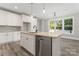 Modern kitchen with island, stainless steel dishwasher, and white cabinets at 4448 Triumph Sw Dr, Concord, NC 28027