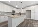 Modern kitchen with white cabinets, granite countertops, and stainless steel appliances at 4448 Triumph Sw Dr, Concord, NC 28027