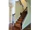 Elegant staircase with dark wood and wrought iron railing at 6209 Treehouse Dr, Charlotte, NC 28214