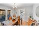 Bright dining room with glass-top table and view into the kitchen at 939 Autumnwood Ln, Charlotte, NC 28213