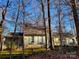 Two-story house nestled in a wooded area with a front porch at 939 Autumnwood Ln, Charlotte, NC 28213