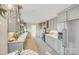 Modern kitchen with stainless steel appliances and gray cabinets at 939 Autumnwood Ln, Charlotte, NC 28213