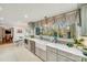 Kitchen features a farmhouse sink, gray cabinets, and a view to the backyard at 939 Autumnwood Ln, Charlotte, NC 28213