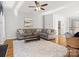 Living room with sectional sofa, hardwood floors, and ceiling fan at 1030 Pepperwood Pl, Clover, SC 29710