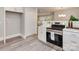 Modern kitchen with white cabinets, stainless steel range and a pantry at 1156 Brighton Pl, Charlotte, NC 28205