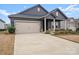 House exterior showcasing gray siding, neutral landscaping, and a two-car garage at 11818 Red Leaf Dr, Charlotte, NC 28215