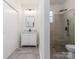 Elegant bathroom with white vanity, marble countertop and a walk in shower at 138 Pounds Sw Ave, Concord, NC 28025